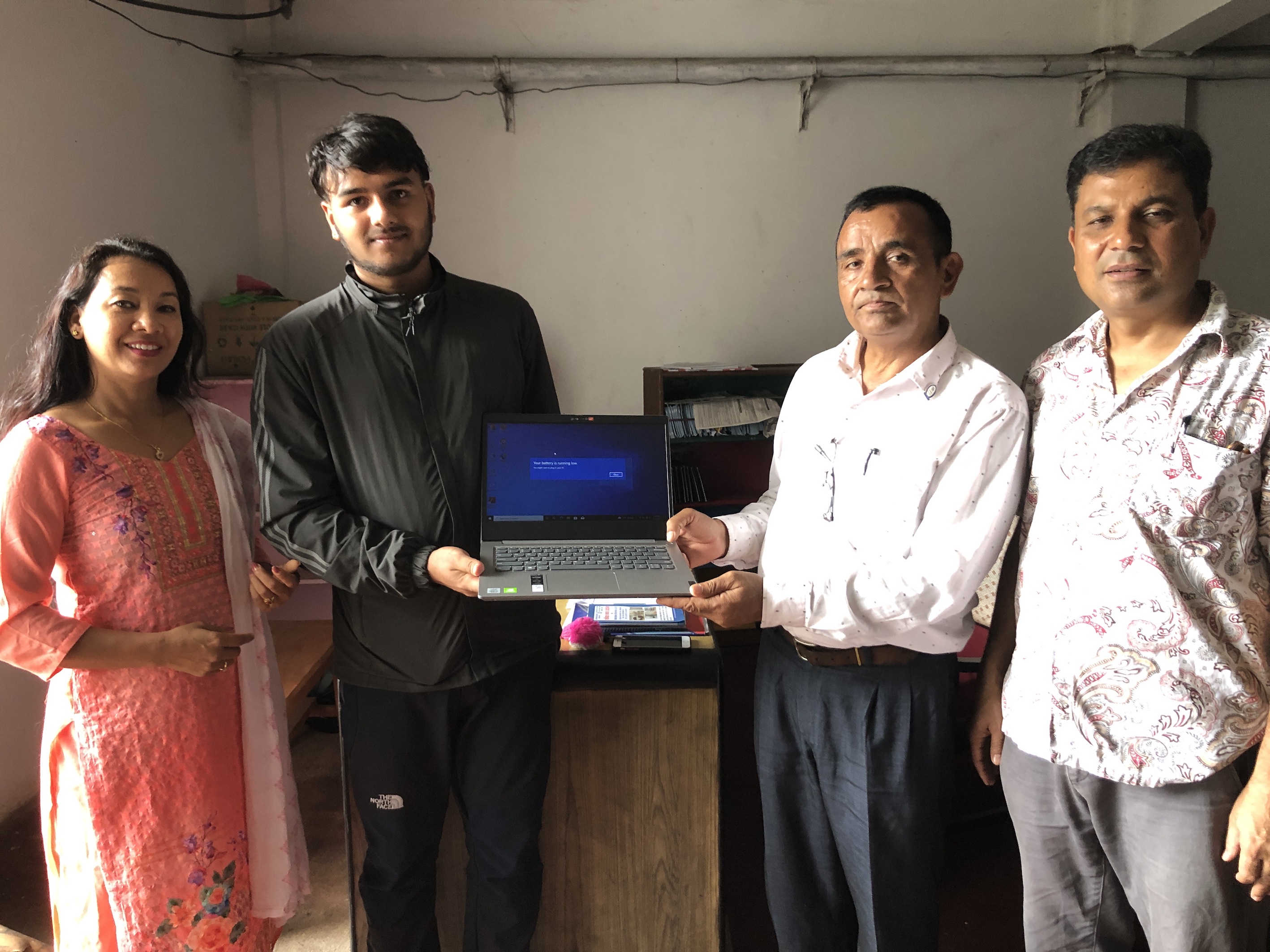 Handing over the laptop to Dibas