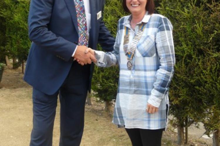 New President Mel Hughes is congratulated by outgoing President Andrew.